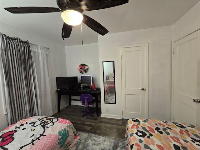 bedroom featuring ceiling fan, baseboards, and wood finished floors