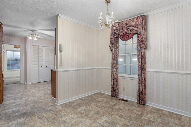 unfurnished dining area with a textured ceiling and ceiling fan with notable chandelier