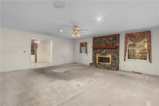 unfurnished living room featuring carpet flooring, ornamental molding, and a fireplace