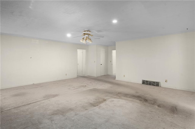 carpeted empty room featuring crown molding and ceiling fan