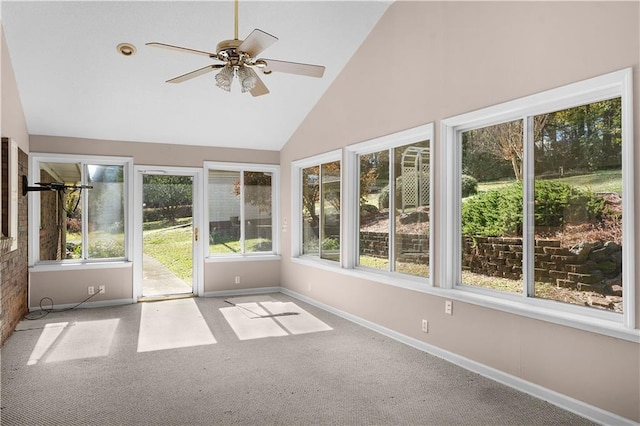 unfurnished sunroom featuring ceiling fan, plenty of natural light, and lofted ceiling