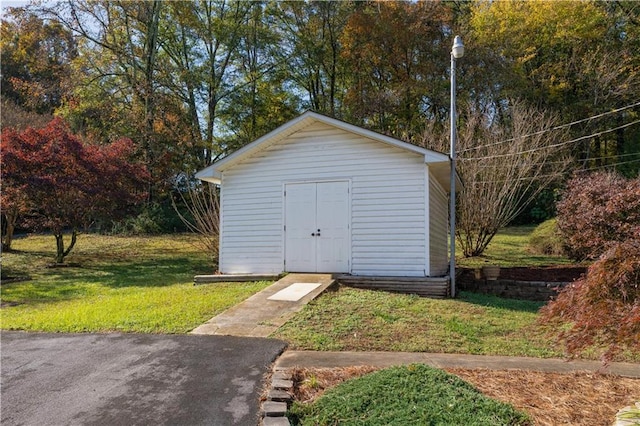 view of outbuilding featuring a yard