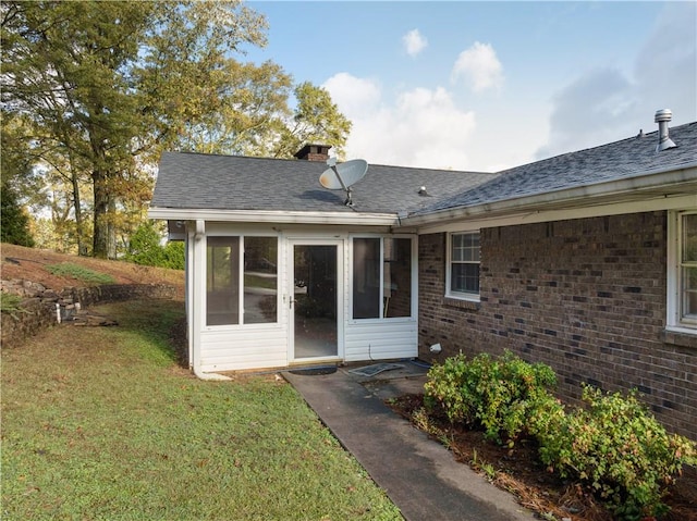 rear view of property with a lawn