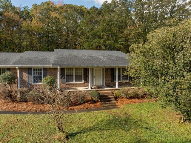 ranch-style house with a front yard and a porch