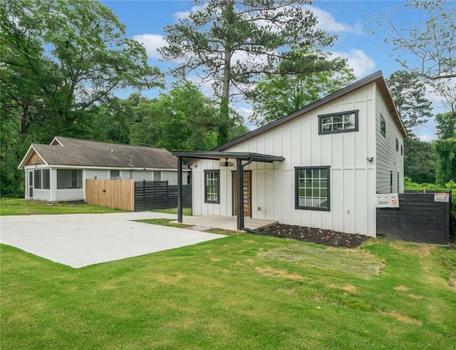 2822 Waters Rd SW, Atlanta, GA 30354 - back of house featuring board and batten siding, a patio, and a sunroom