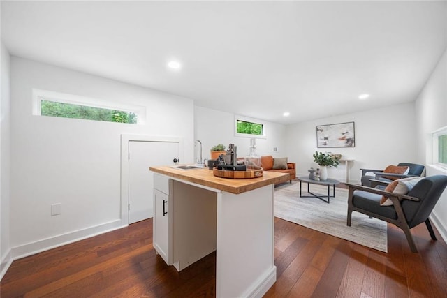2822 Waters Rd SW, Atlanta, GA 30354 - kitchen featuring butcher block counters, a sink, dark wood-style floors, a center island with sink, and recessed lighting