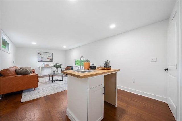 2822 Waters Rd SW, Atlanta, GA 30354 - kitchen featuring a sink, wood counters, dark wood-type flooring, white cabinetry, and recessed lighting