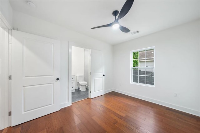 2822 Waters Rd SW, Atlanta, GA 30354 - unfurnished bedroom with dark wood finished floors, baseboards, ensuite bath, and a ceiling fan