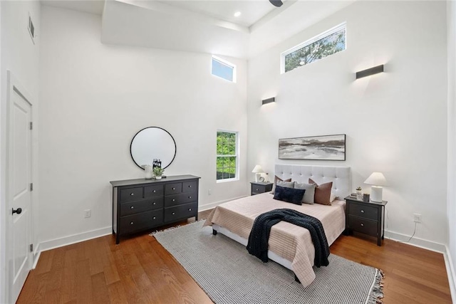 2822 Waters Rd SW, Atlanta, GA 30354 - bedroom with a towering ceiling, multiple windows, wood finished floors, and baseboards