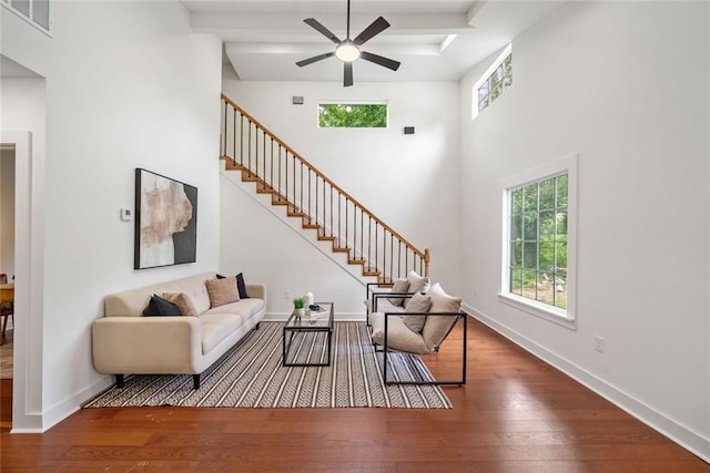 2822 Waters Rd SW, Atlanta, GA 30354 - living room featuring a ceiling fan, hardwood / wood-style floors, stairway, baseboards, and a towering ceiling