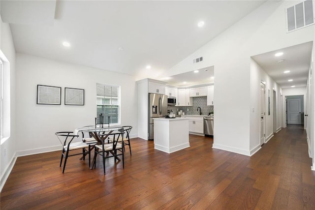 2822 Waters Rd SW, Atlanta, GA 30354 - dining space with vaulted ceiling, dark wood-style flooring, baseboards, and recessed lighting