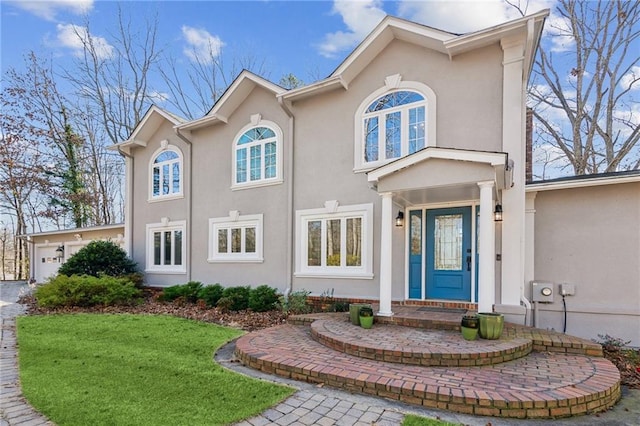 view of front of home with a garage and a front lawn