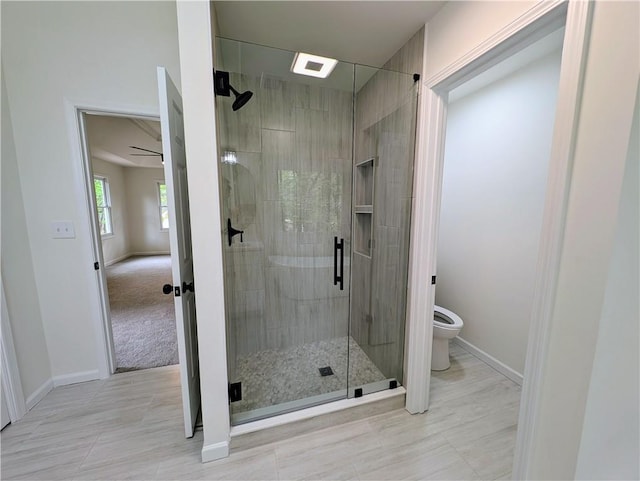 full bath featuring baseboards, toilet, and a shower stall