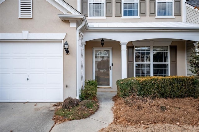 view of exterior entry with a garage