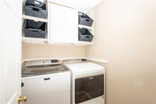 washroom with cabinets and separate washer and dryer