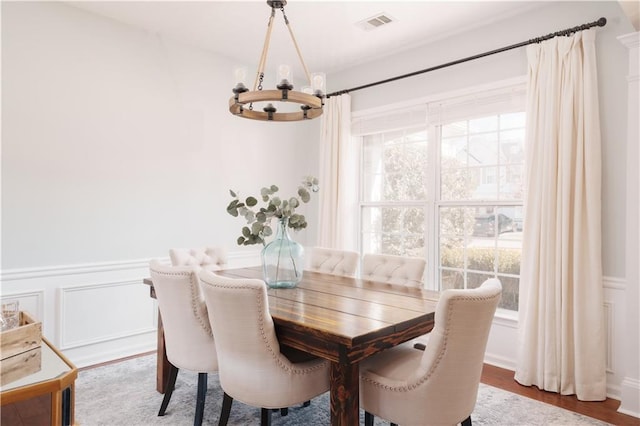 dining room with hardwood / wood-style flooring and a chandelier