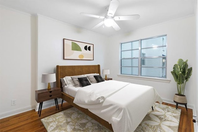 bedroom featuring ceiling fan, dark hardwood / wood-style flooring, and ornamental molding