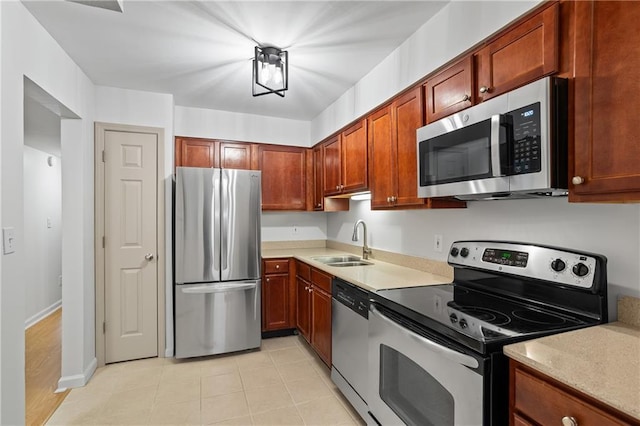 kitchen with light tile patterned floors, sink, and appliances with stainless steel finishes