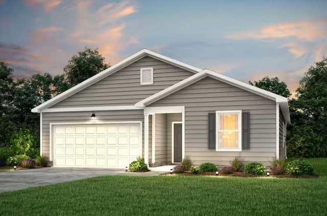 view of front of home featuring a garage and a lawn