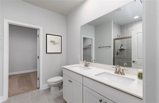 bathroom with vanity, a shower with shower door, tile patterned flooring, and toilet