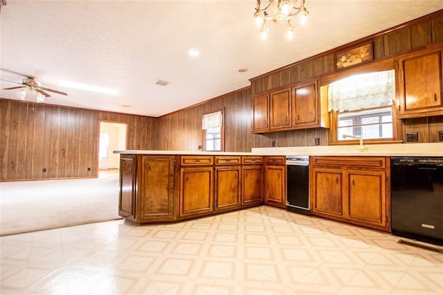 kitchen with light colored carpet, dishwasher, sink, and wood walls