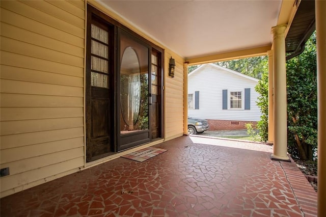 view of exterior entry with covered porch