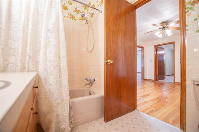 bathroom with vanity, hardwood / wood-style flooring, ceiling fan, and shower / bath combo with shower curtain