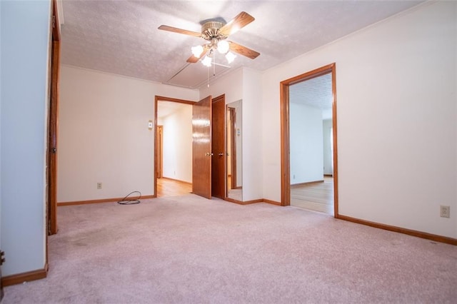 carpeted spare room with ceiling fan and a textured ceiling