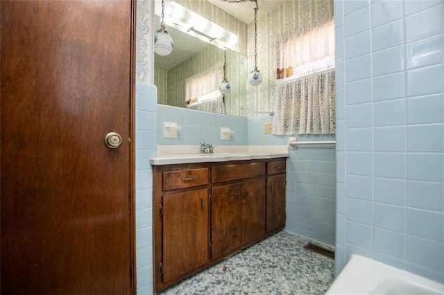 bathroom featuring tile walls and vanity