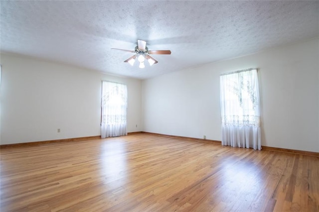 unfurnished room with ceiling fan, light hardwood / wood-style floors, and a textured ceiling