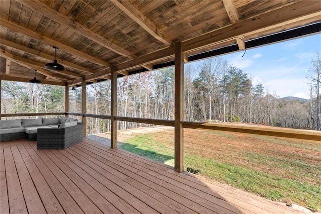 wooden deck with an outdoor living space and ceiling fan