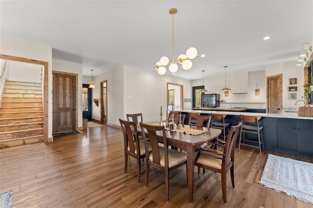 dining space with an inviting chandelier and dark hardwood / wood-style flooring