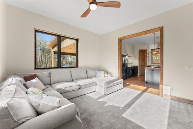 living room with ceiling fan and light wood-type flooring