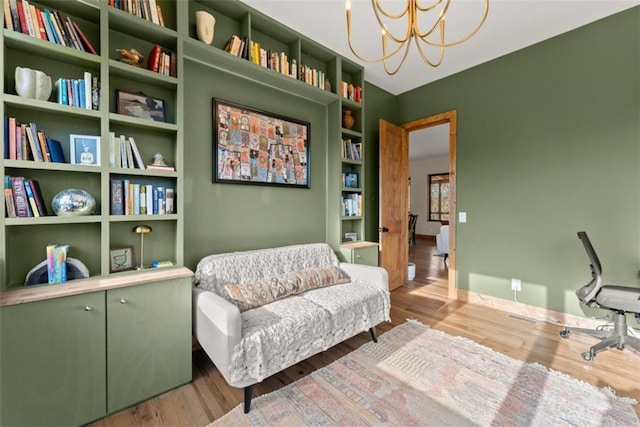 living area with a notable chandelier and light hardwood / wood-style floors