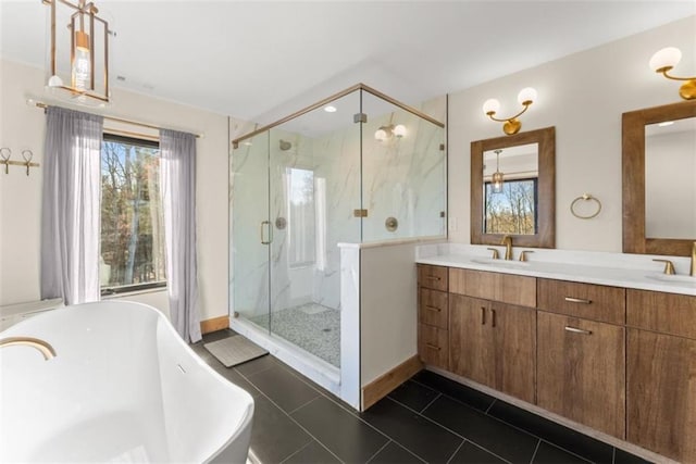 bathroom with tile patterned floors, plus walk in shower, and vanity