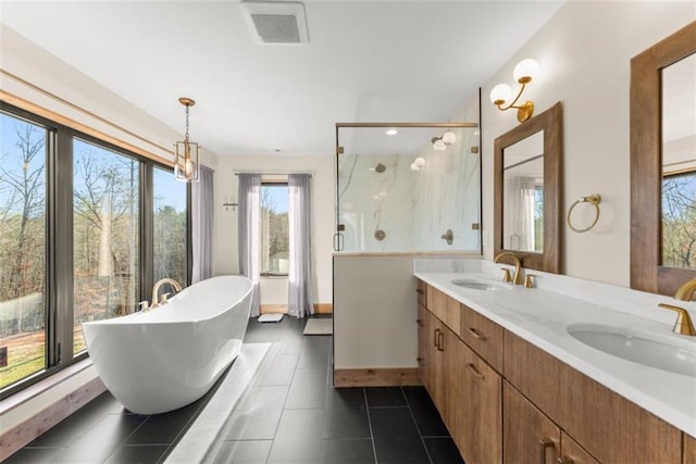 bathroom featuring vanity, tile patterned floors, and separate shower and tub