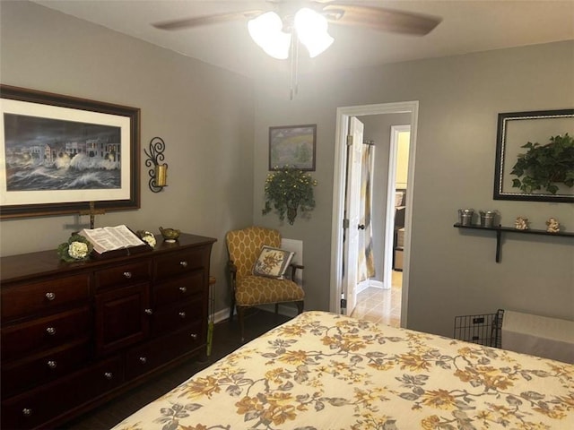 bedroom with ensuite bath, ceiling fan, and dark wood-type flooring