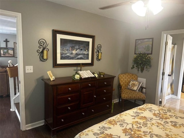 bedroom with ceiling fan and dark hardwood / wood-style flooring