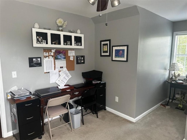 carpeted office space with ceiling fan