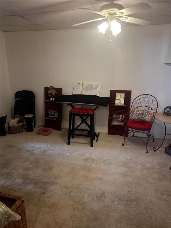 living area with ceiling fan and carpet floors