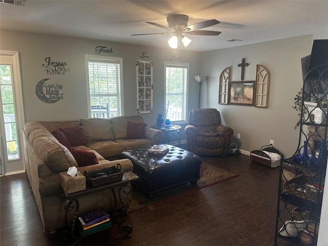 living room with ceiling fan and dark wood-type flooring