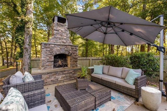 view of patio / terrace with an outdoor living space with a fireplace