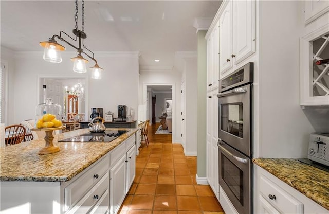 kitchen with white cabinetry, a kitchen island, decorative light fixtures, black electric cooktop, and light tile patterned floors