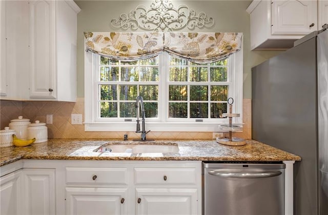 kitchen featuring sink, white cabinetry, and stainless steel appliances