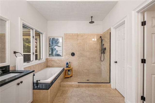 bathroom featuring tile patterned flooring, vanity, and shower with separate bathtub