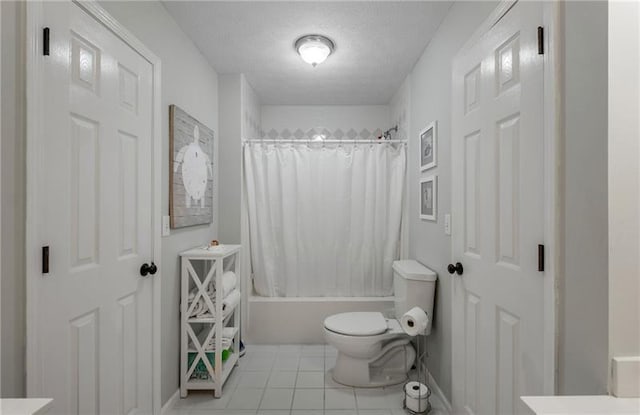 bathroom featuring a textured ceiling, tile patterned floors, shower / tub combo, and toilet