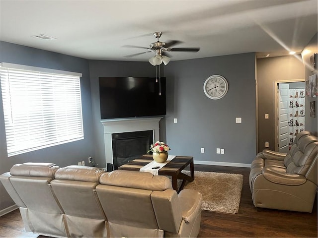 living room featuring dark hardwood / wood-style floors and ceiling fan