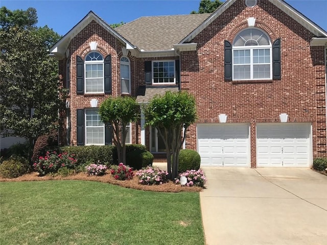 view of front of property with brick siding, roof with shingles, a garage, driveway, and a front lawn