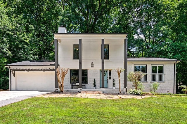 view of front of property featuring a garage and a front lawn