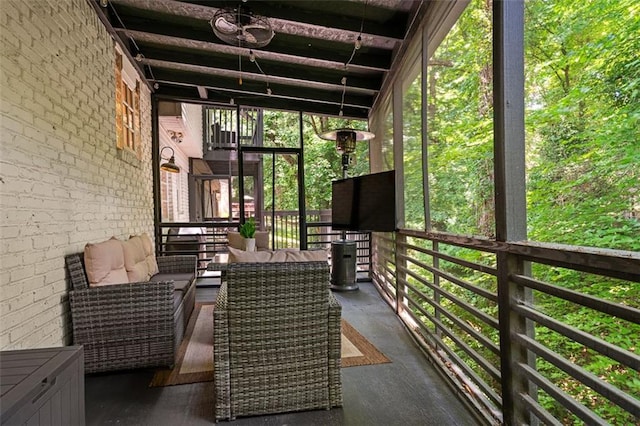 unfurnished sunroom with beam ceiling